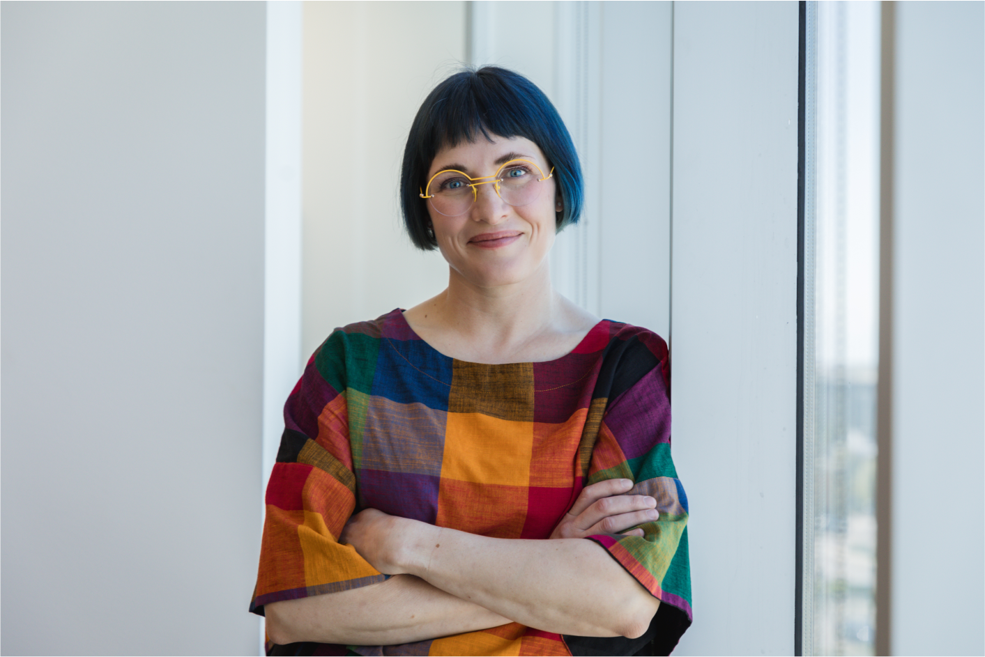Portrait of Laura Leavitt standing by a window